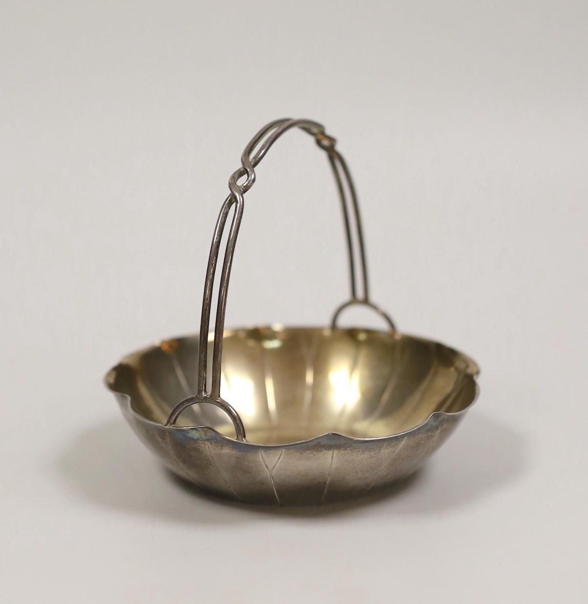 A Chinese white metal lotus leaf sweetmeat basket by Wang Hing, Hong Kong, diameter 10.7cm, 109 grams.